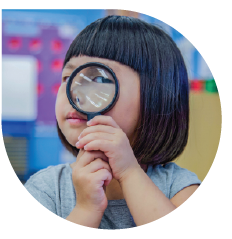 Child with magnifying glass