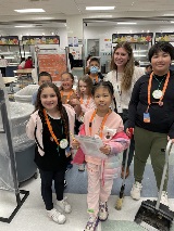 Students survey their cafeteria for waste.