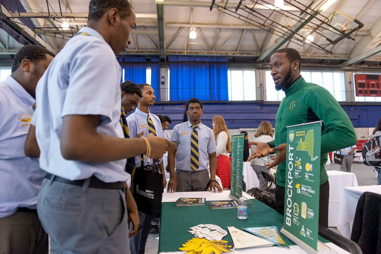 Students holding CUNY banner during college application week