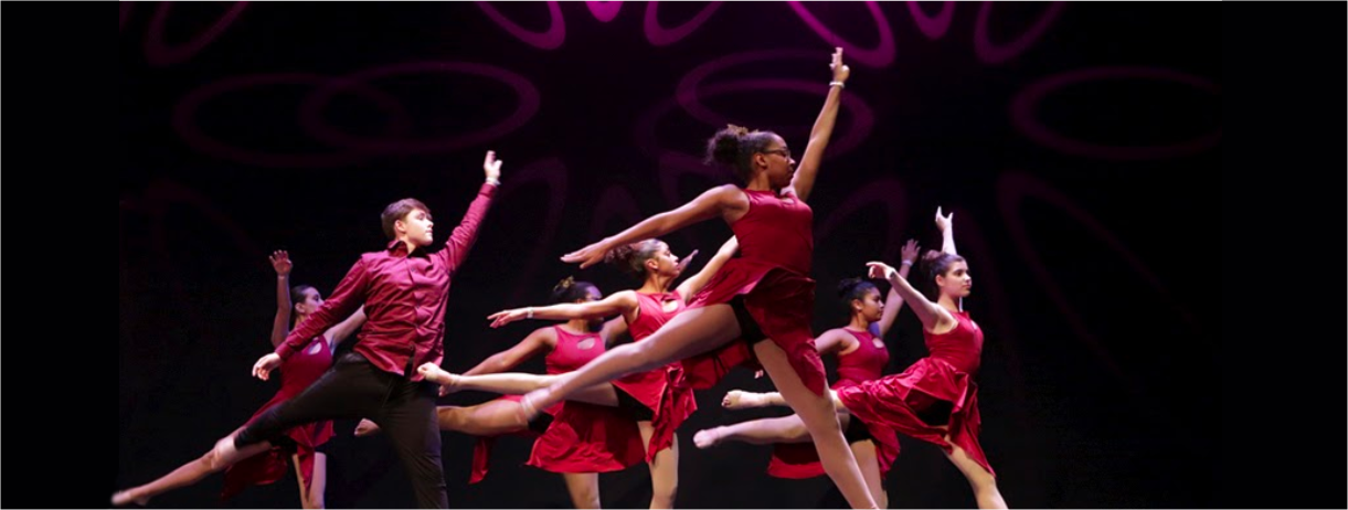 Girls and boys in burgundy clothing dancing