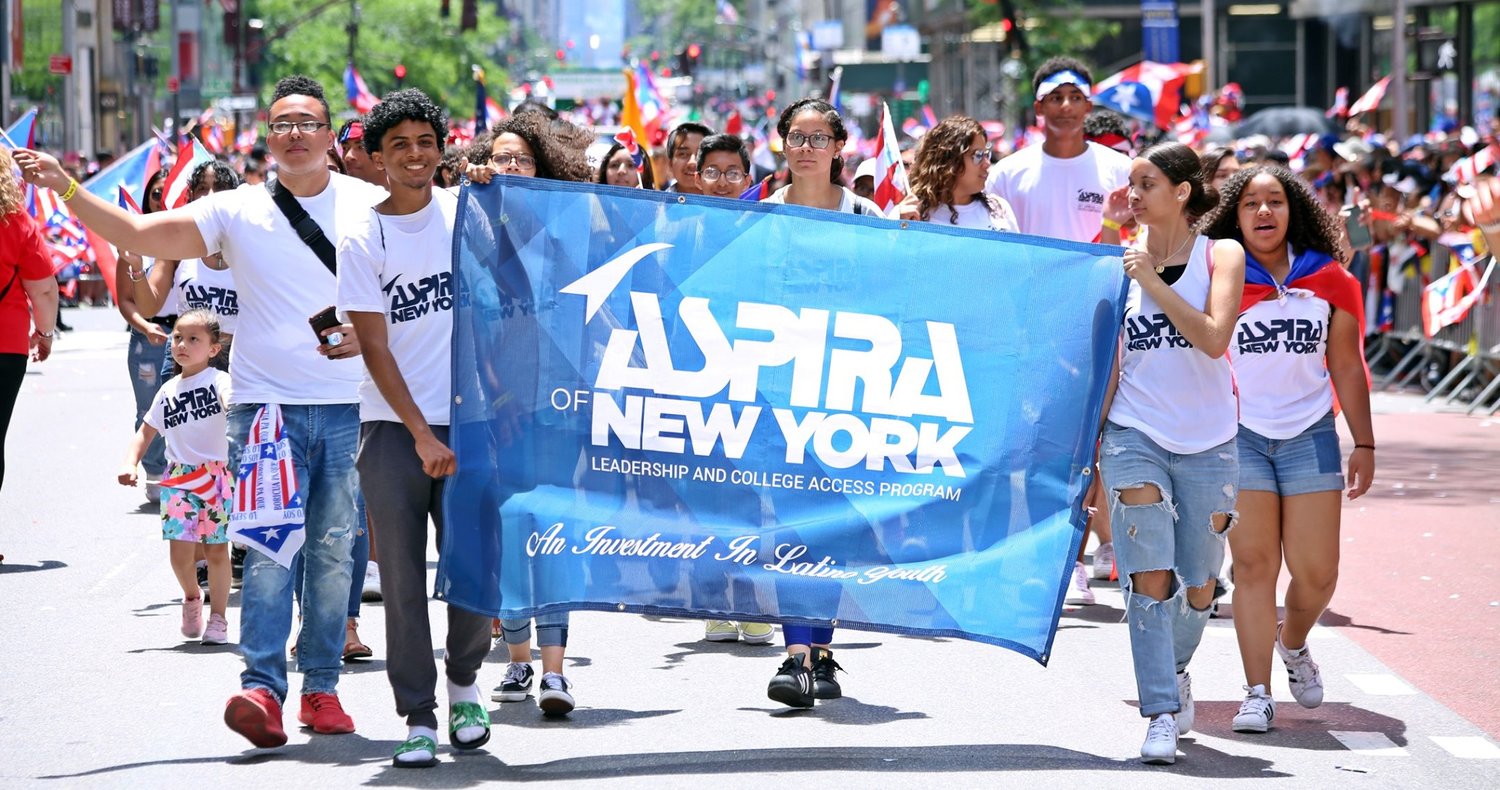 ASPIRA-of-NY-Banner Teenagers carrying the ASPIRA of NY banner during the Puerto Rican Day Parade