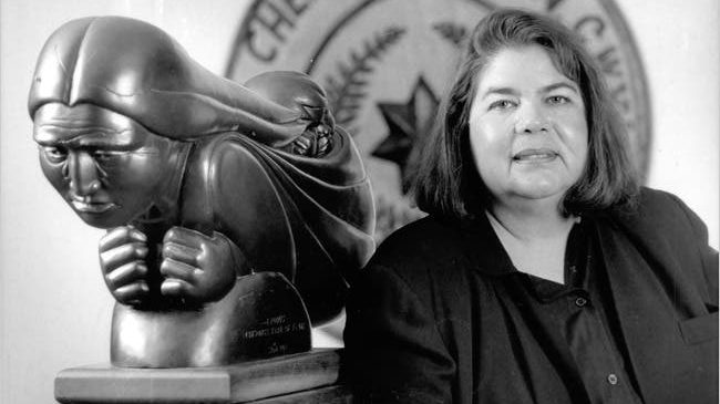 Wilma-Mankiller-2 Wilma Mankiller (right) standing next to sculpture of Native American woman