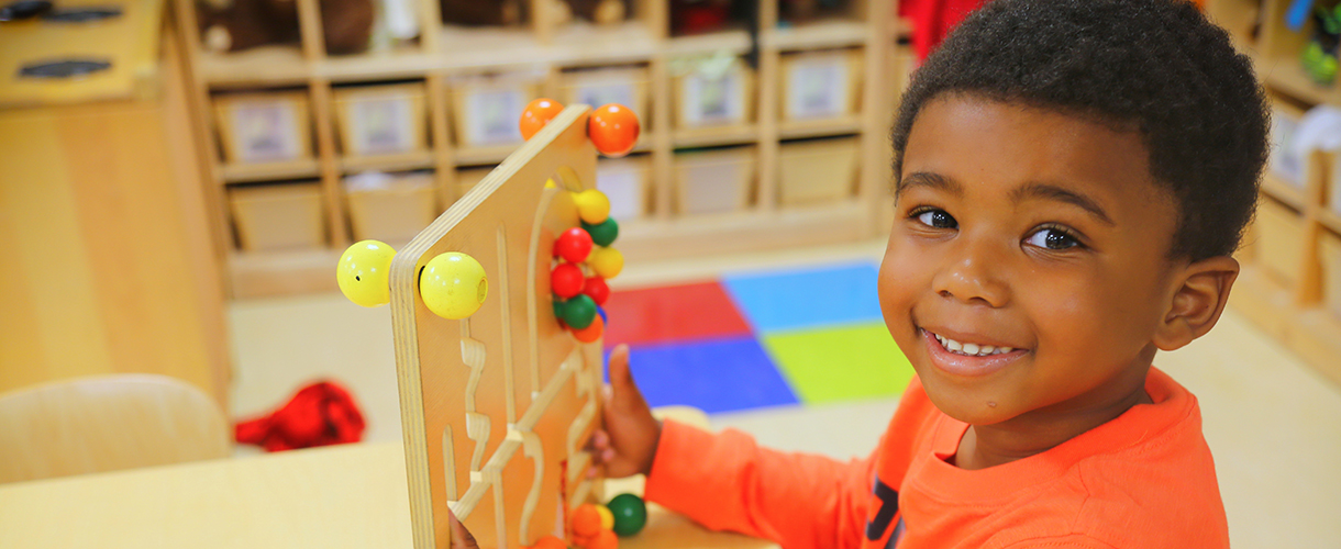 young boy playing with puzzle