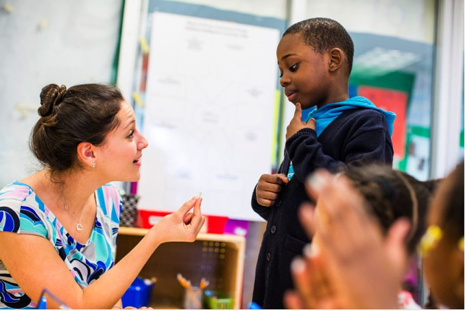 A child asks his teacher a question. 