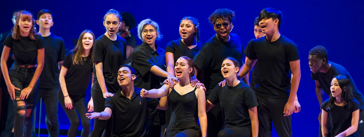 Children dressed in black singing