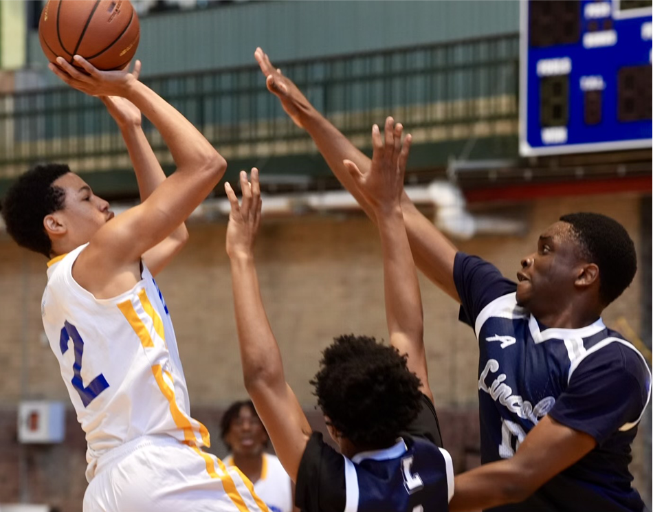 A high school basketball player attempting a jumpshot over the outstretched arms of two defenders wearing Lincoln HS uniforms.