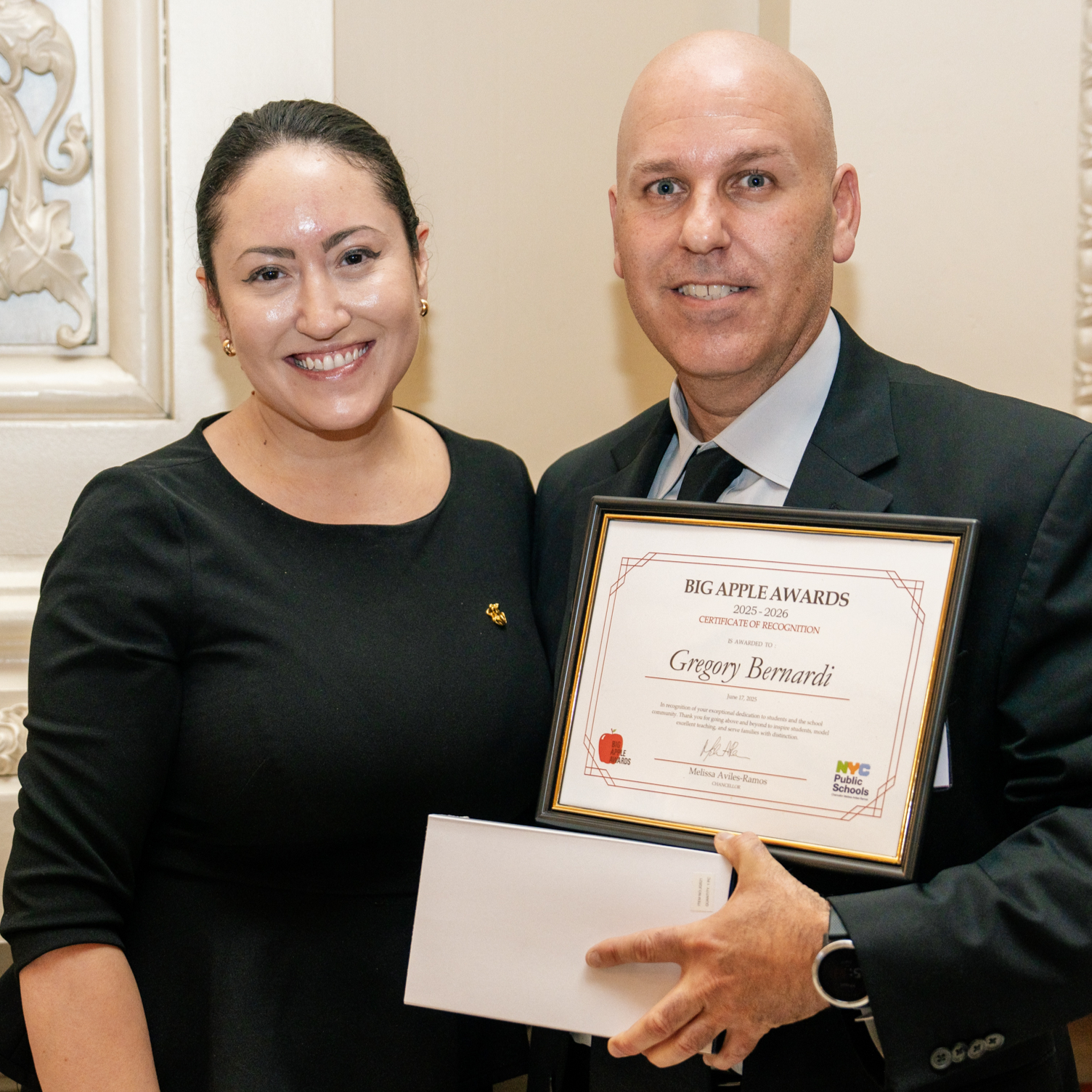 2025 Big Apple Award winner Gregory Bernardi receives his awards from Chancellor Aviles-Ramos