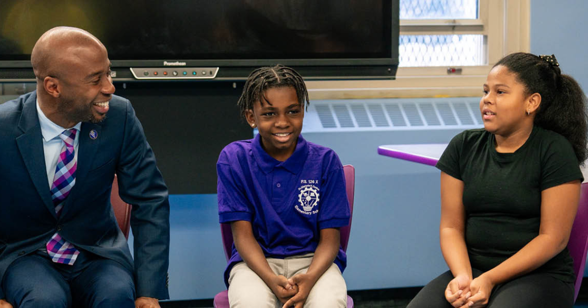 Chancellor Samuels speaks with students in their classroom