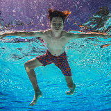 Photo of young person smiling while underwater.