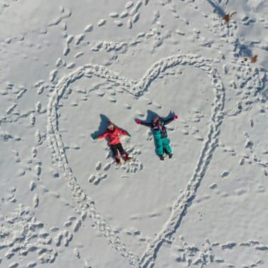 Children making snow angels in the snow