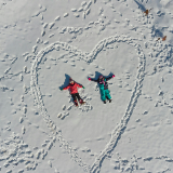 Children making snow angels in the snow