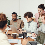 Group of adults at a table in a meeting with each other