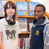 Two students in a library.