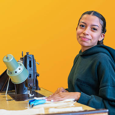 A student using a sewing machine