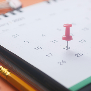 Close-up of a push-pin marking the 18th day of a calendar.