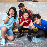Students play outside their school with chalk