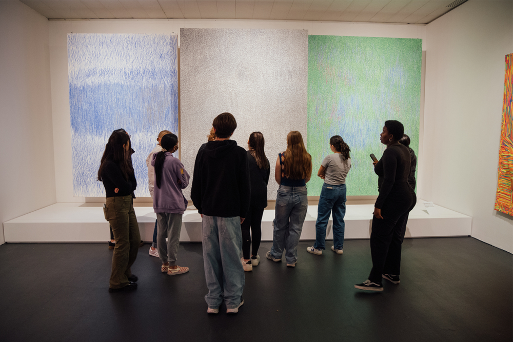 View of a group of young people viewing a painted work hanging on a wall of the Jewish Museum