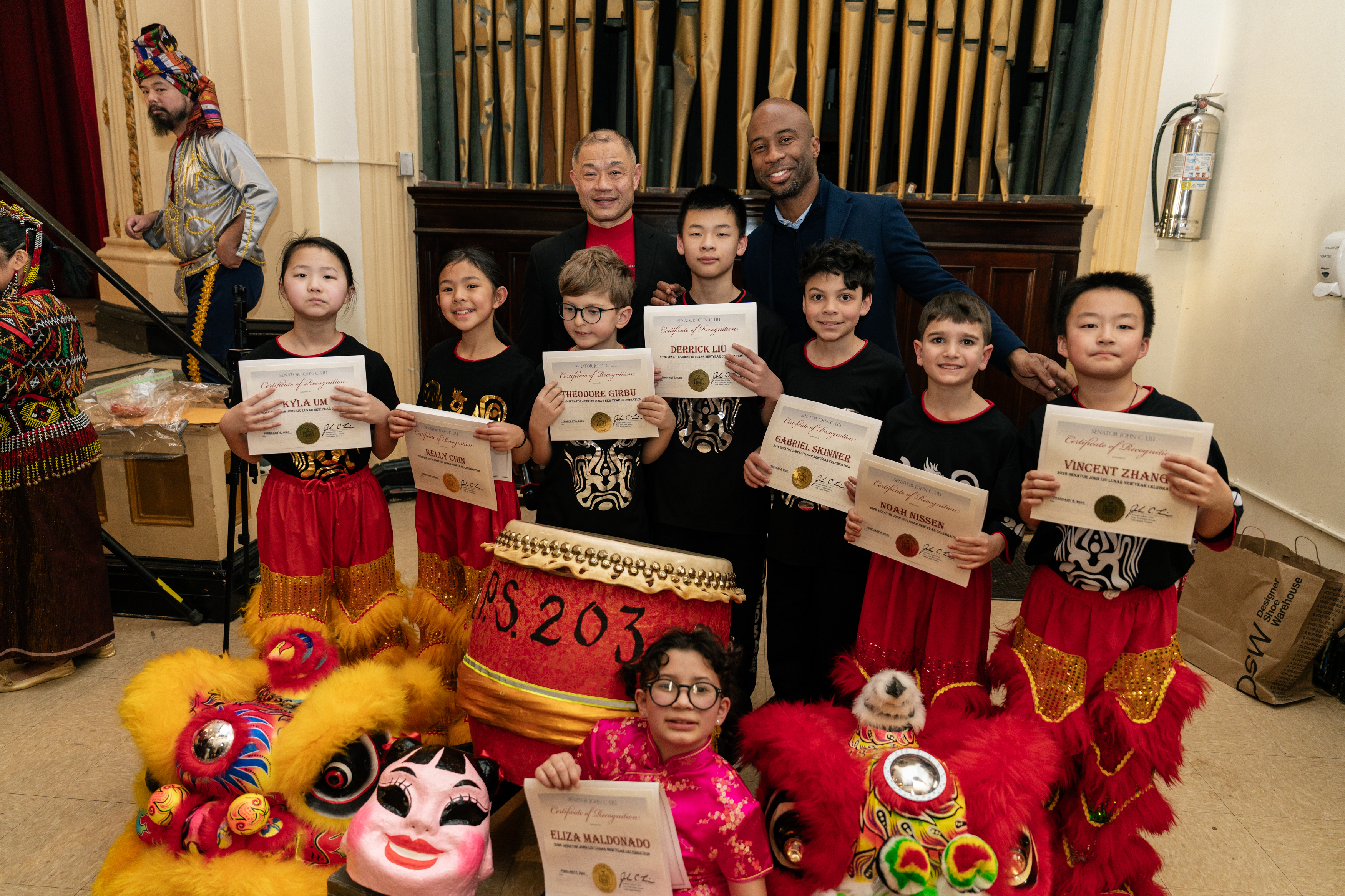 A group of students from the P.S. 203Q Lion Dance troupe celebrating Lunar New Year with Senator John Liu and Chancellor Kamar Samuels.