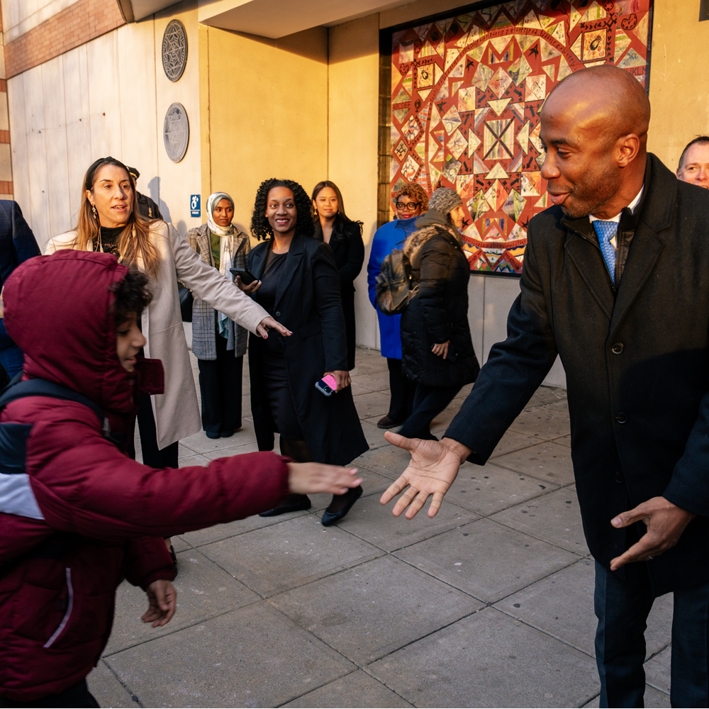 Chancellor Shaking Student's Hand at PS 194 Entrance