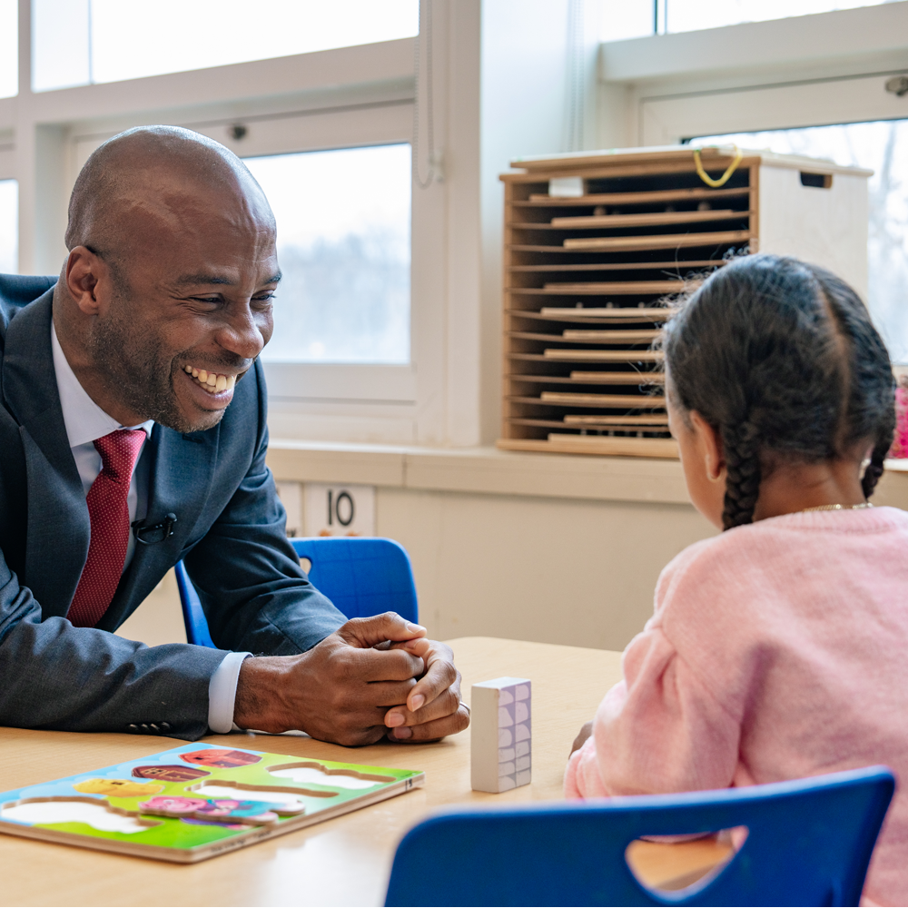 Chancellor Sitting with Child at Mosaic PreK (Square)