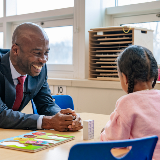 Chancellor Sitting with Child at Mosaic PreK (Square)