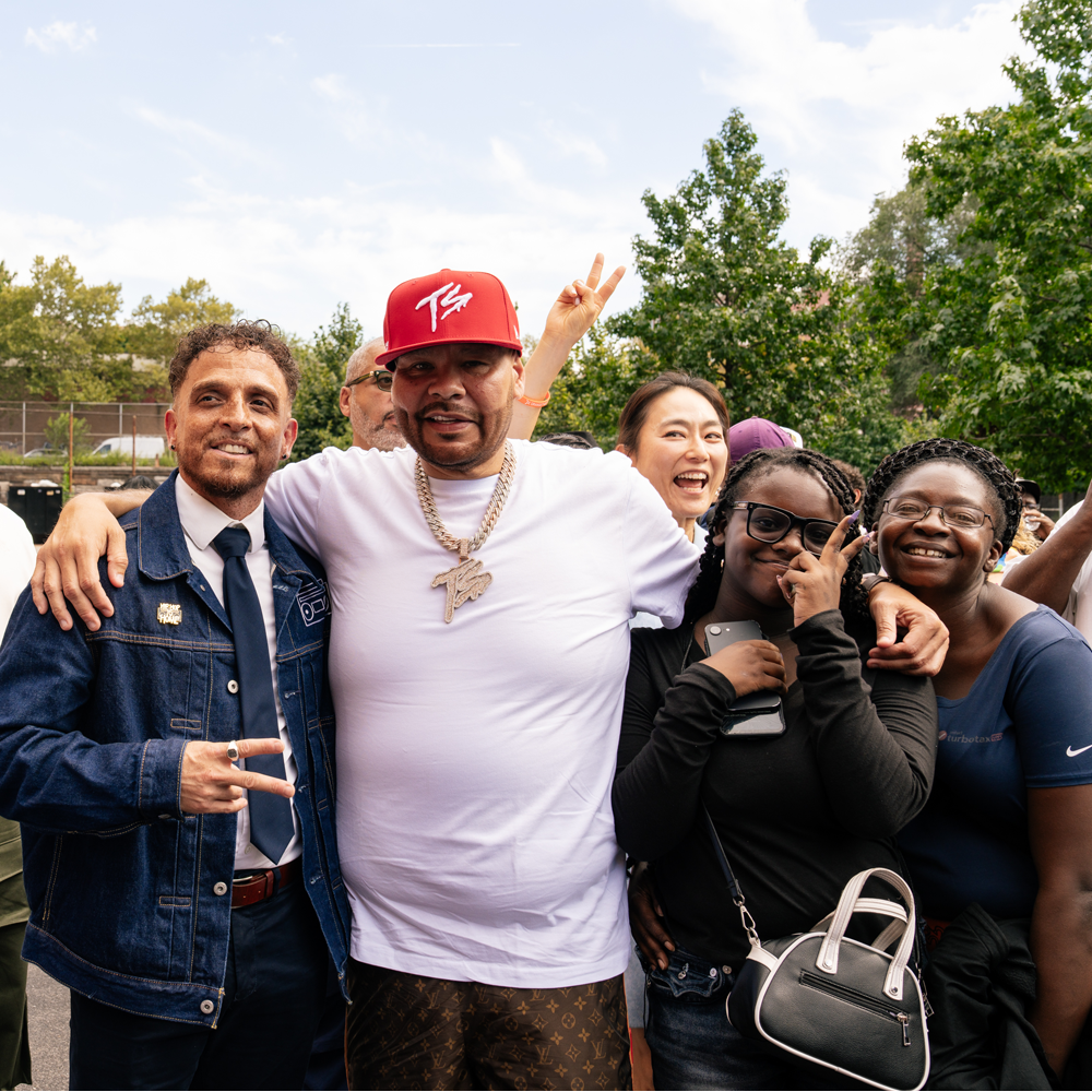 Principal Jason Reyes (left) of the new Bronx School of Hip Hop standing with Fat Joe (center), and two students (right of Fat Joe)