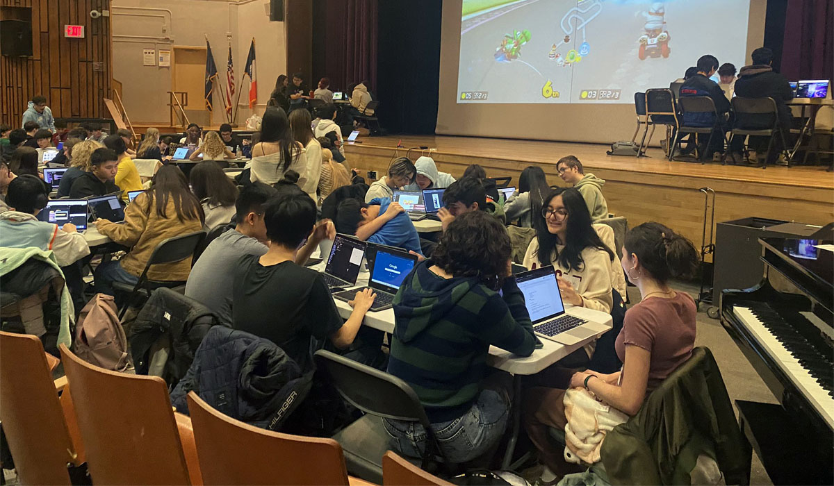 Group of Tottenville HS students participating in a Hackathon in their school auditorium.