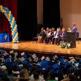 Chancellor Kamar Samuels delivering a speech at a podium during Martin Van Buren High School's 2026 graduation.