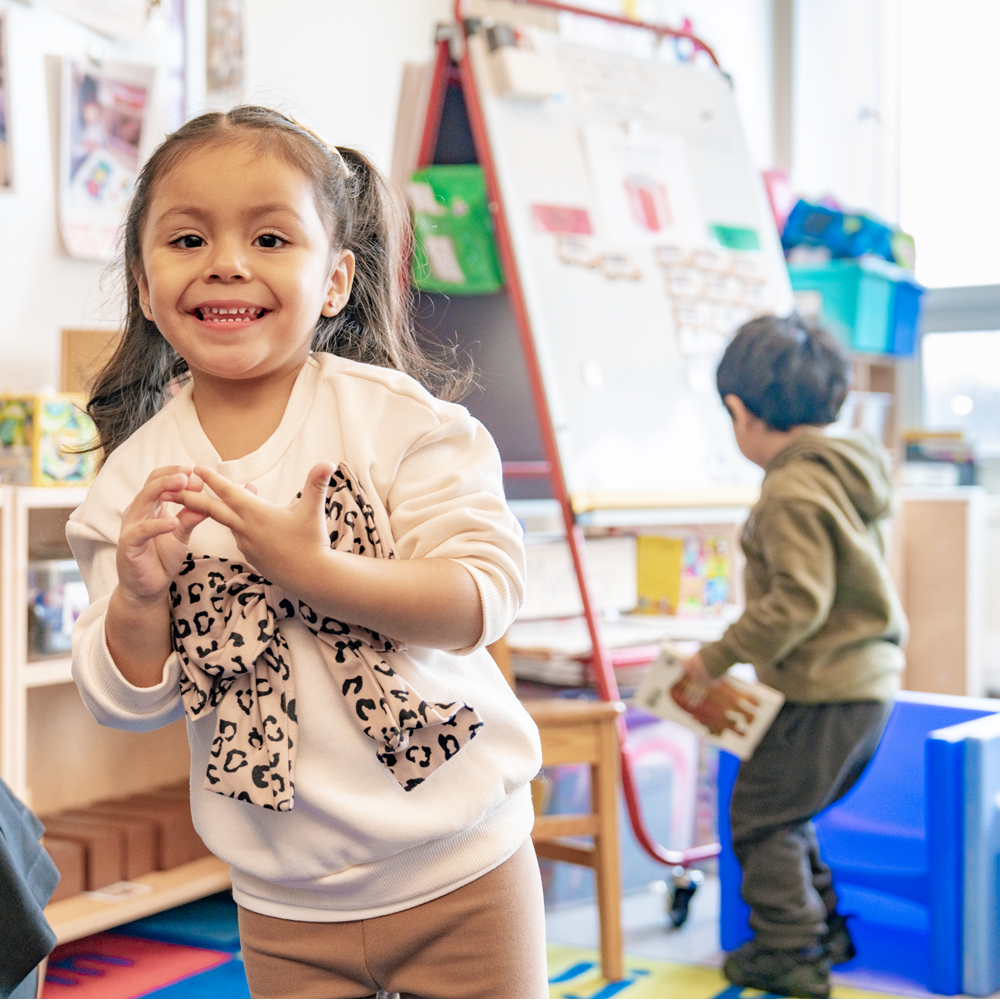 Mosaic PreK Student Smiling at Camera