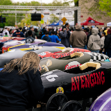 Side view of a row of over a dozen soap box cars