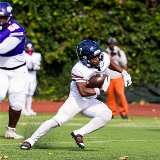 Zy'eare Schulters (Eagle Academy II) running with football on field