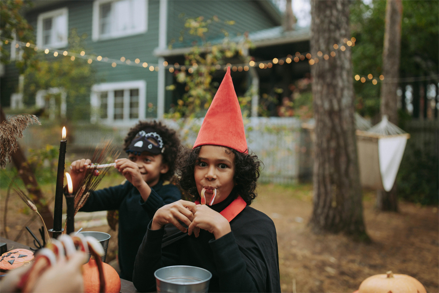 Two middle school-aged kids in Halloween costumes, with the student on the right looking right at the camera.