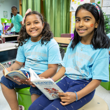 Two students reading in their classroom